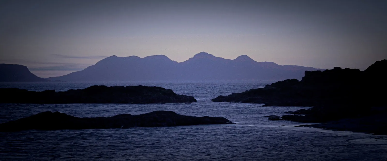 Distant mountains across the sound at dusk